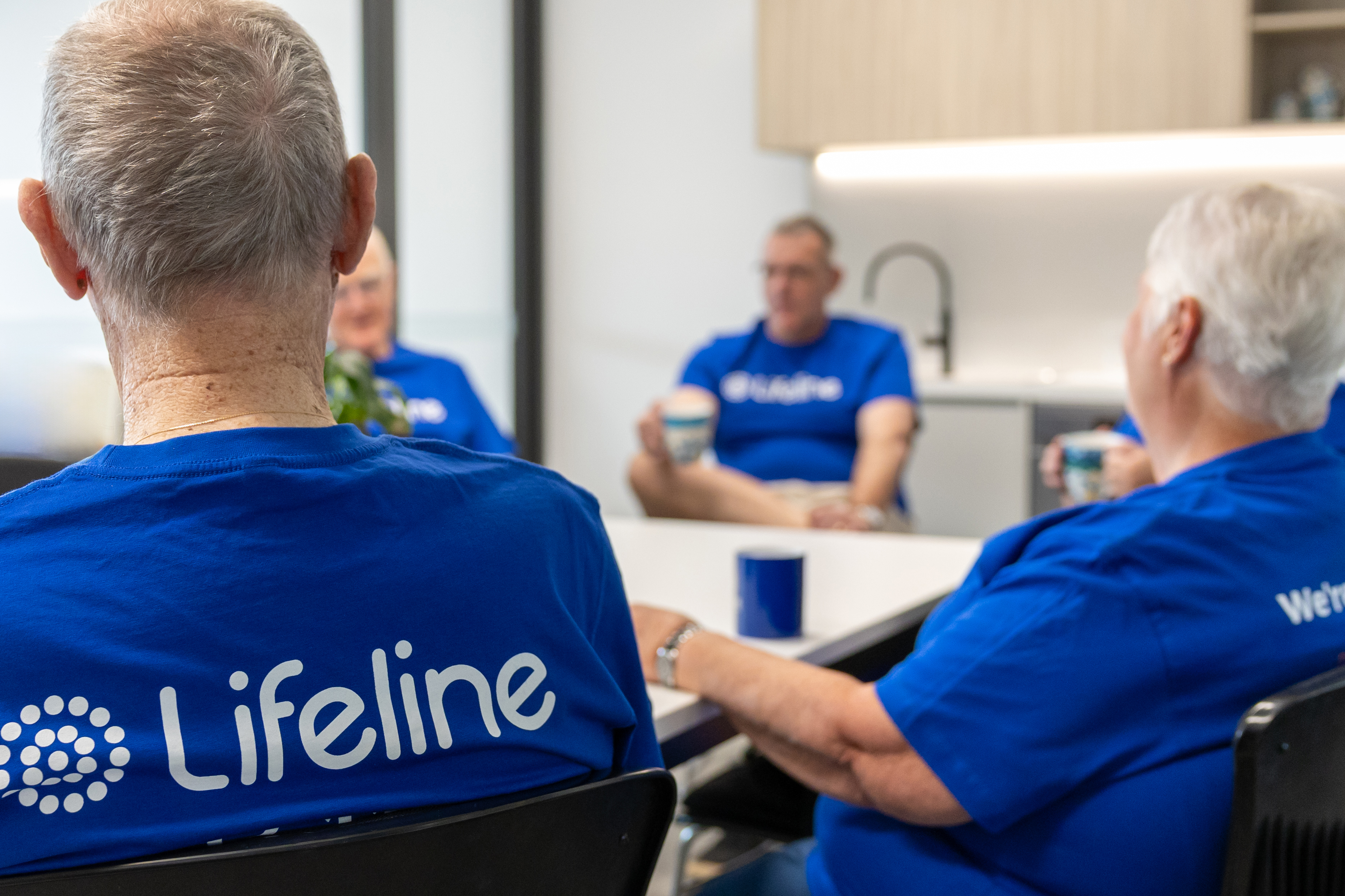 Lifeline crisis supporters sitting in gorup with back to camera