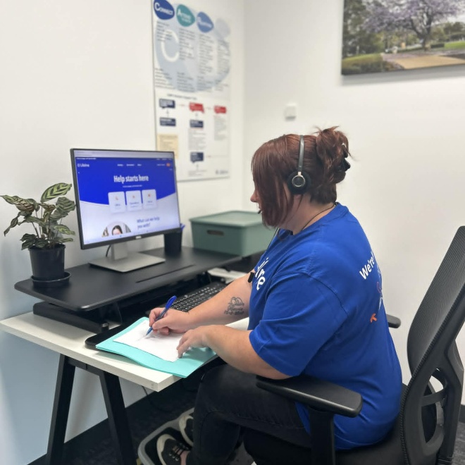 Female crisis supporter taking calls