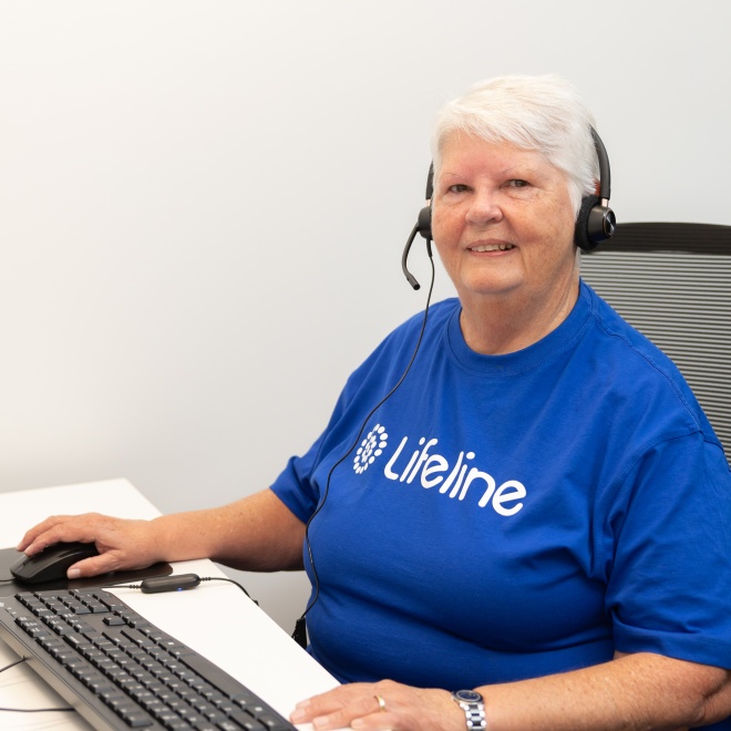 Female crisis supporter sitting at work station