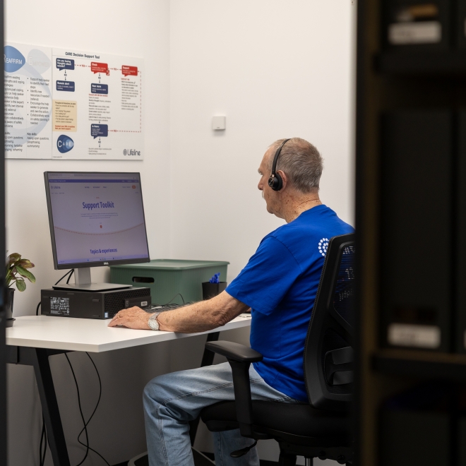 Crisis supporter sitting in phone room on a call