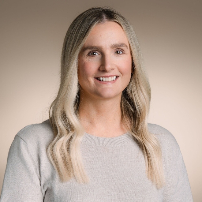 Woman looking at camera with bland background