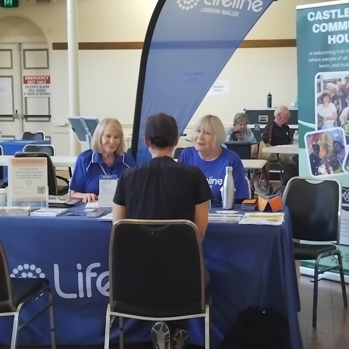 Volunteers sitting at table listening