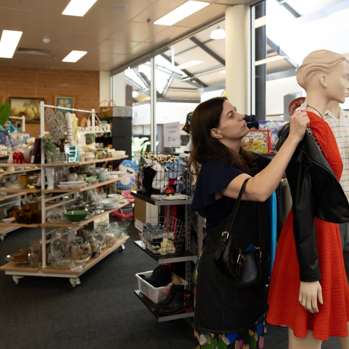 Woman dressing model in store
