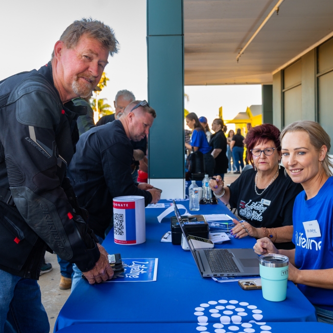 Motorbike rider checking in with Lifeline staff member