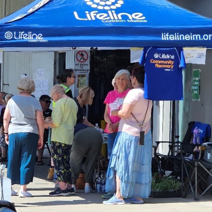 People standing talking under LLM gazebo