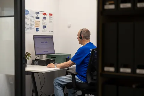 Crisis supporter sitting in phone room on a call