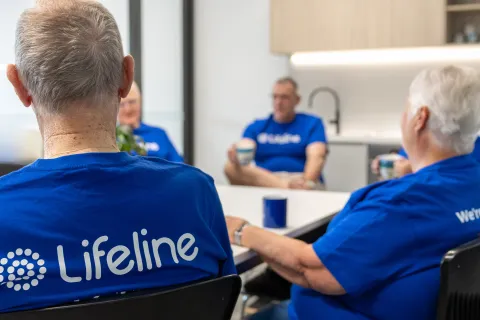 Lifeline crisis supporters sitting in gorup with back to camera